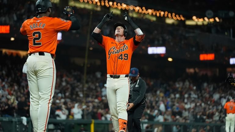 San Francisco Giants' Tyler Fitzgerald (49) celebrates in front of...