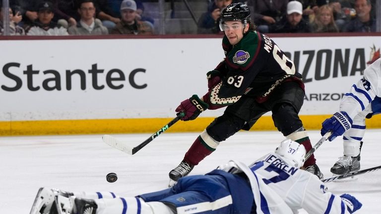 Arizona Coyotes left wing Matias Maccelli (63) shoots over Toronto...