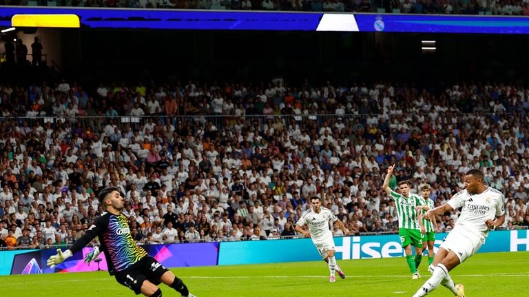 Real Madrid's Kylian Mbappe, right, scores his sides first goal...