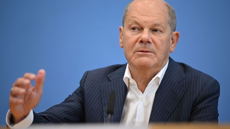 German Chancellor Olaf Scholz addresses the media during his summer...