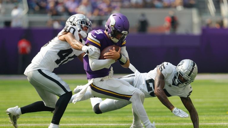 Minnesota Vikings quarterback J.J. McCarthy (9) is hit by Las...