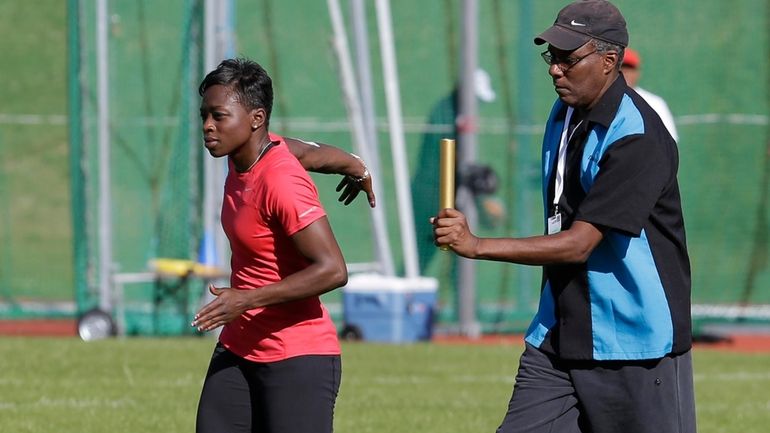 U.S. runner Jeneba Tarmoh, left, trains with her coach, Bobby...