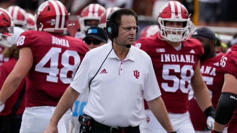 Indiana head coach Curt Cignetti, center, watches the first half...