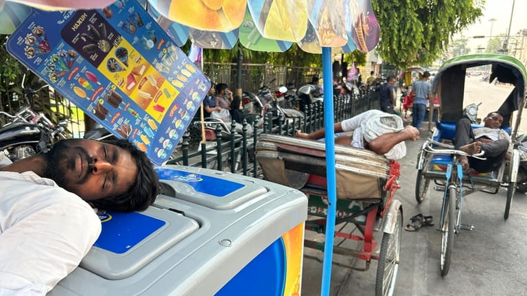 An ice cream vendor and rickshaw pullers sleep as severe...