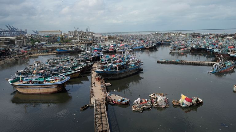 Fishing boats are anchored at a fishing harbor after weather...