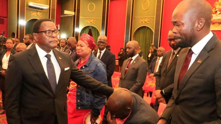 Malawian President Lazarus Chakwera, left, greets people in Lilongwe, Tuesday,...
