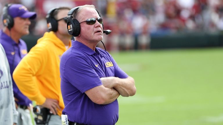 LSU head coach Brian Kelly looks at the scoreboard after...