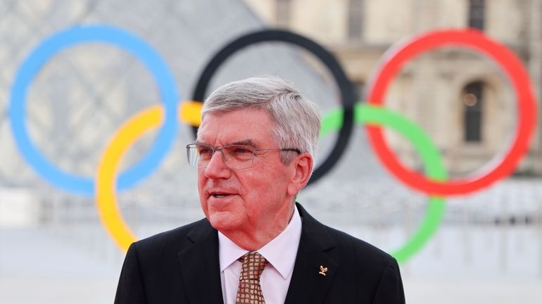 Thomas Bach, left, President of the International Olympic Committee (IOC)...