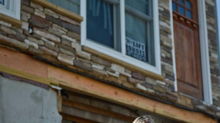 Lisa Mentges sits outside her home in Long Beach. (Aug....