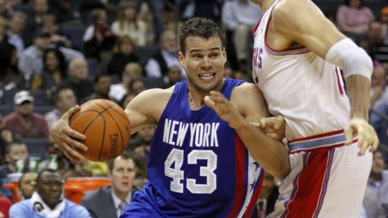 New Jersey Nets' Kris Humphries (43) dribbles around Charlotte Bobcats'...