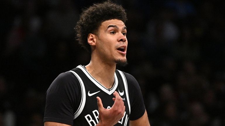 Nets forward Cameron Johnson looks on in the first half...