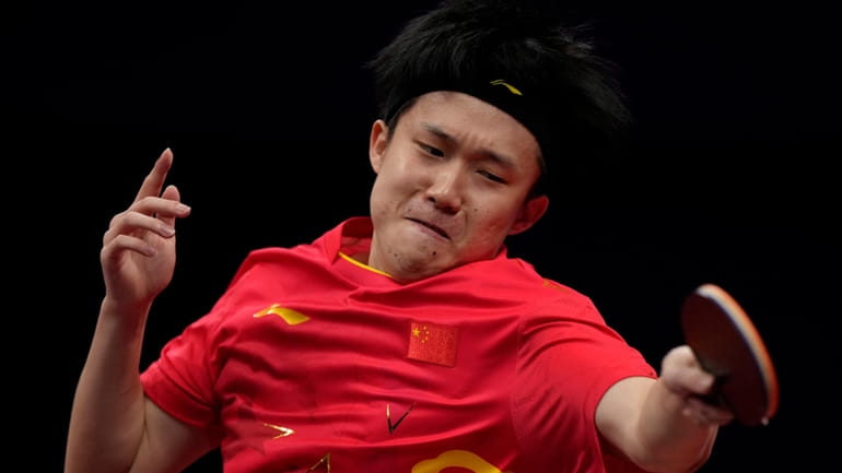 China's Wang Chuqin returns a ball from Hong Kong's Wong...