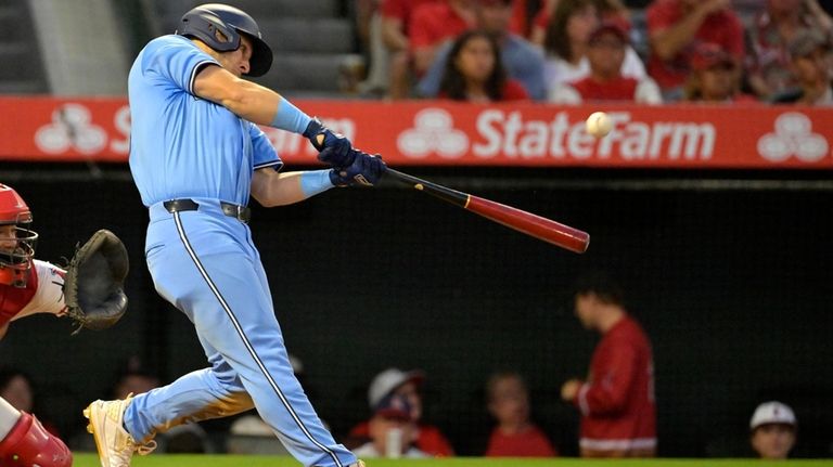 Toronto Blue Jays' Daulton Varsho hits a three-run home run...