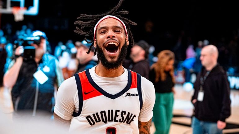 Duquesne's Dae Dae Grant reacts after an NCAA college basketball...