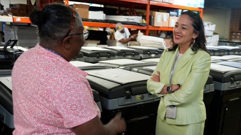 Milwaukee's election administrator Paulina Gutierrez, right, talks to Phyllis Whitley,...