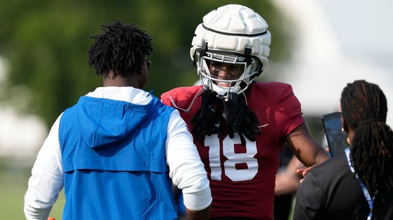 Arizona Cardinals wide receiver Marvin Harrison Jr. (18) talks with...