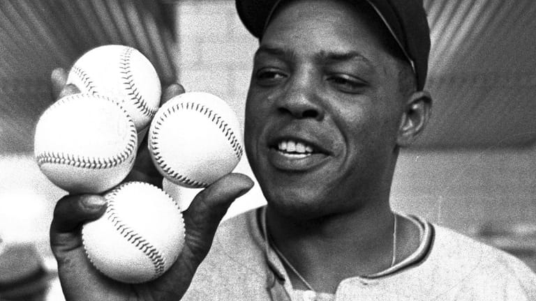 San Francisco Giants outfielder Willie Mays displays the four baseballs...