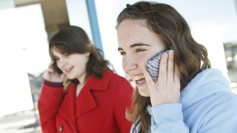 Aimee Manfredo, 14, from Shoreham on her cell phone in...