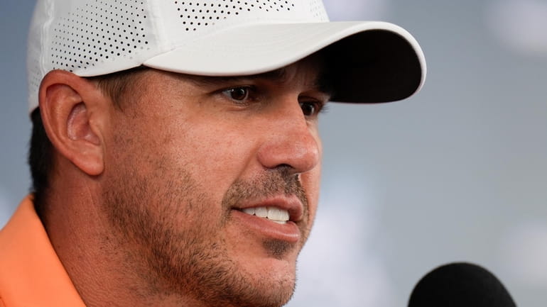 Brooks Koepka speaks during a news conference at the PGA...