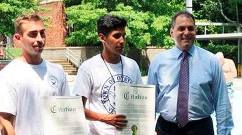 Lifeguards Bryan Rhoads, 25, of Syosset, left, and Andres Martinez,...