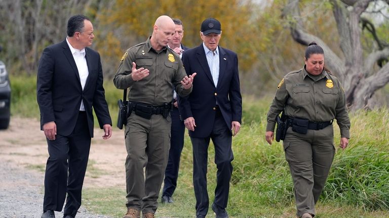 President Joe Biden, center, looks over the southern border, Feb....