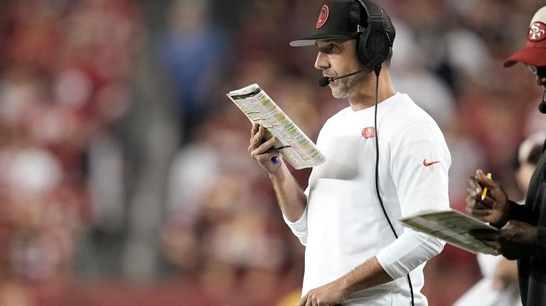 San Francisco 49ers head coach Kyle Shanahan watches from the...