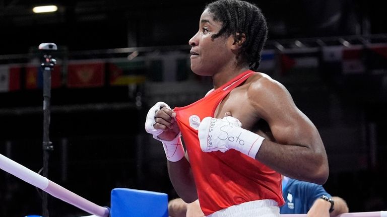 Refugee Olympic Team's Cindy Djankeu celebrates after defeating France's Davina...