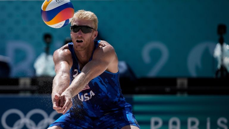 US' Chase Budinger hits the ball during the men's round...