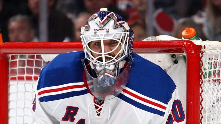 Henrik Lundqvist reacts after a play against the Montreal Canadiens...