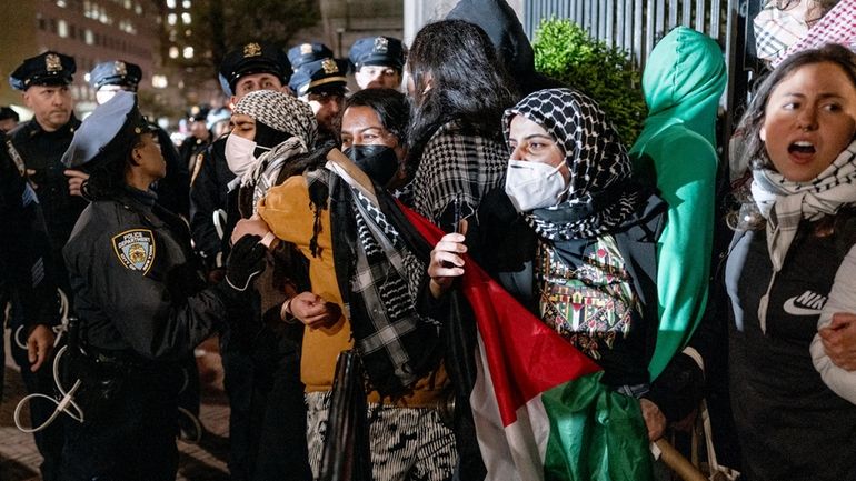 People protesting Israel's conduct of the war in Gaza hold their...