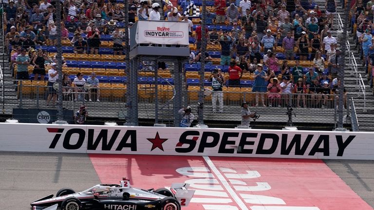 Josef Newgarden crosses the finish line as he wins an...