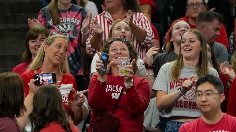 Fans cheer during an NCAA Division I women's college volleyball...