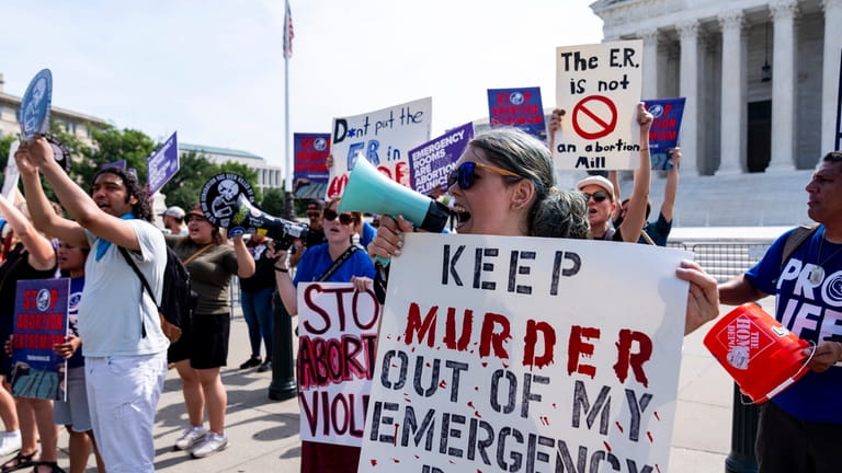 Anti-abortion demonstrators protest outside the Supreme Court, Wednesday, June 26,...