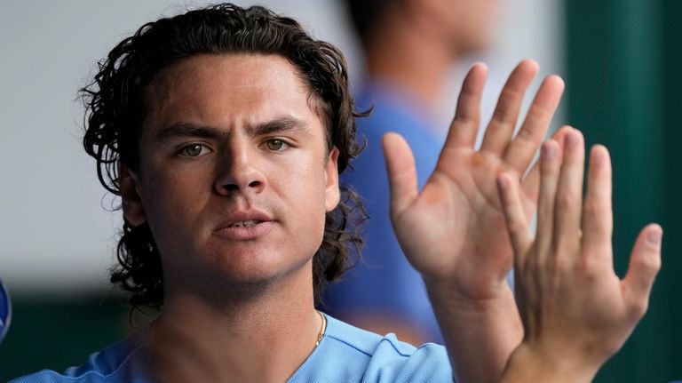 Kansas City Royals' Nick Pratto celebrates in the dugout after...