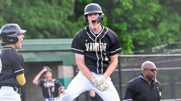 Jack Tate of Wantagh reacts after sliding safely into home...