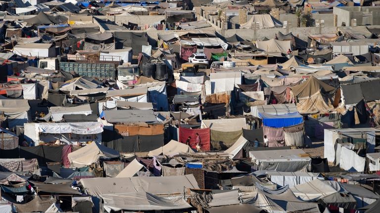 Tents are crammed together as displaced Palestinians camp on the...