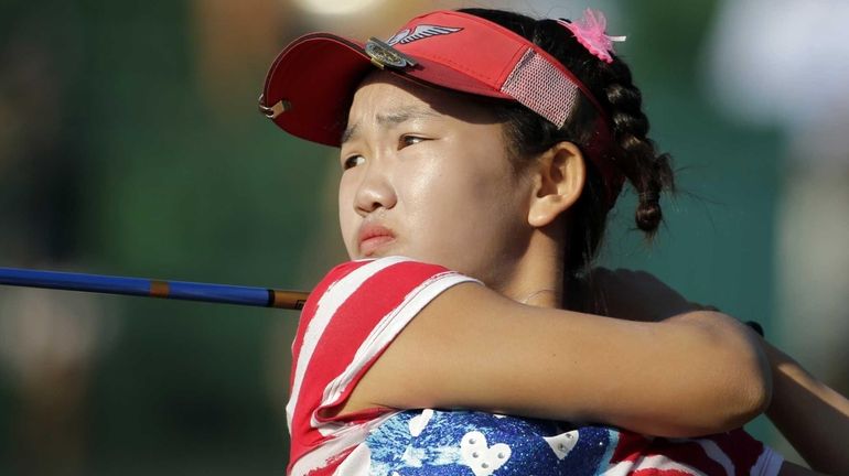 Lucy Li watches her tee shot on the 14th hole...