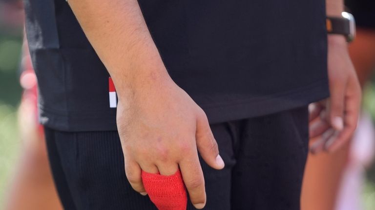 Utah quarterback Cameron Rising (7) has his fingers wrapped following...