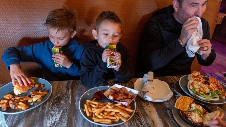 The Mcgann family, of Stony Brook, enjoy lunch at That...