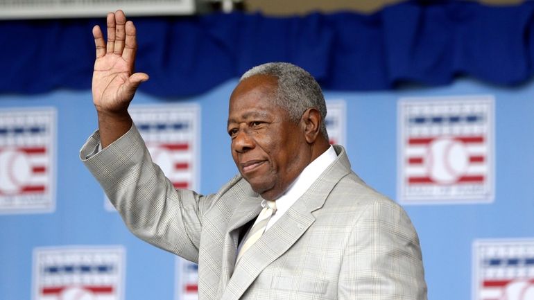 Hall of Famer Hank Aaron waves to the crowd during...