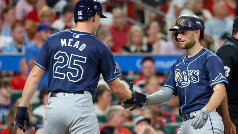 Tampa Bay Rays' Curtis Mead, left, congratulates teammate Brandon Lowe...