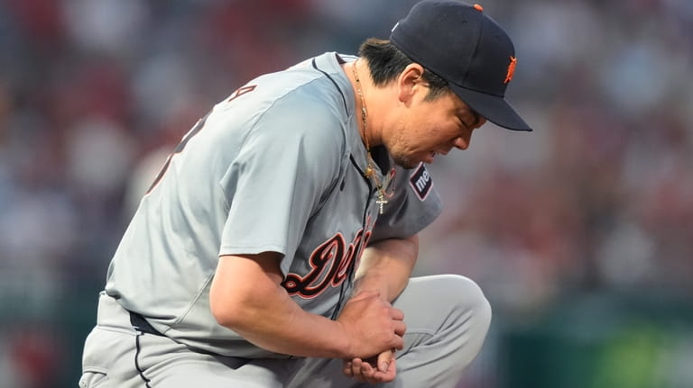 Detroit Tigers starting pitcher Kenta Maeda reacts after deflecting a...