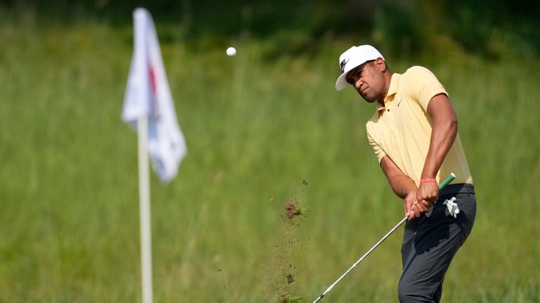 Tony Finau chips on the third green during the first...