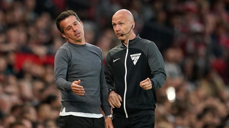 Fulham's head coach Marco Silva, left, reacts as he talks...