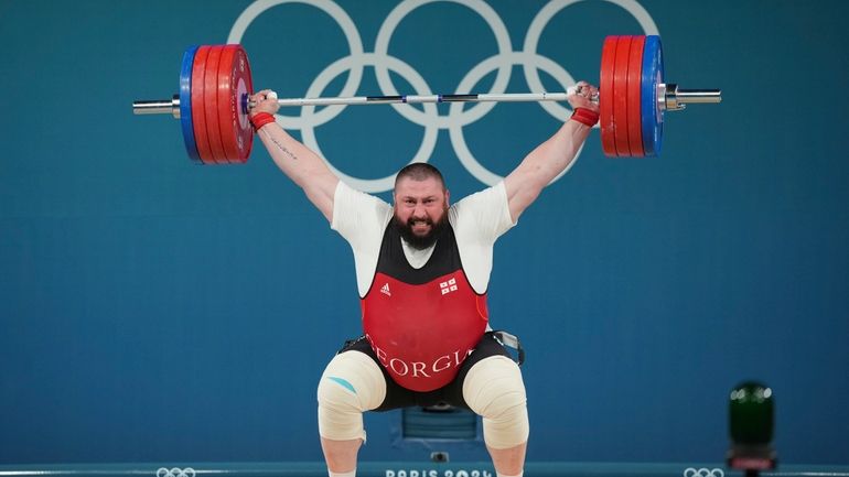 Lasha Talakhadze of Georgia competes during the men's +102kg weightlifting...