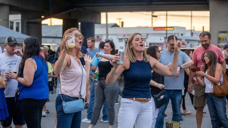 Colleen Himmel, of Bellmore, and Bridget Conaghan, of Massapequa, sing...