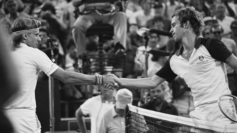 John McEnroe, right, shakes hands after beating Bjorn Borg, left,...