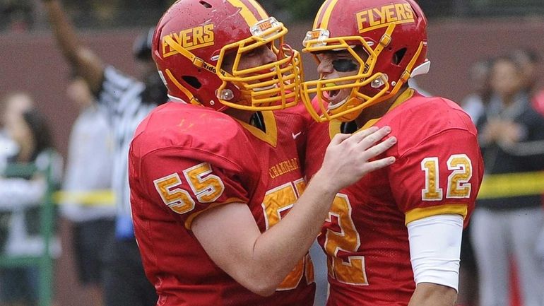 Chaminade offensive lineman Gerard Arnold congratulates quarterback Sean Cerrone on...