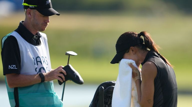 Lydia Ko, of New Zealand, cries and wipes her tears...