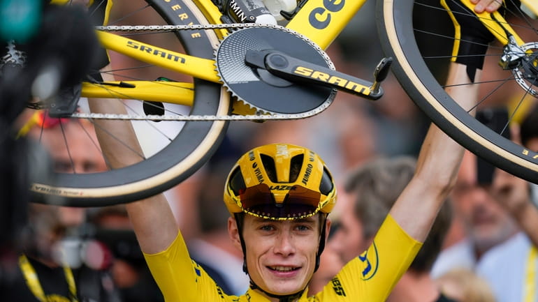 FILE -Tour de France winner Denmark's Jonas Vingegaard, wearing the...